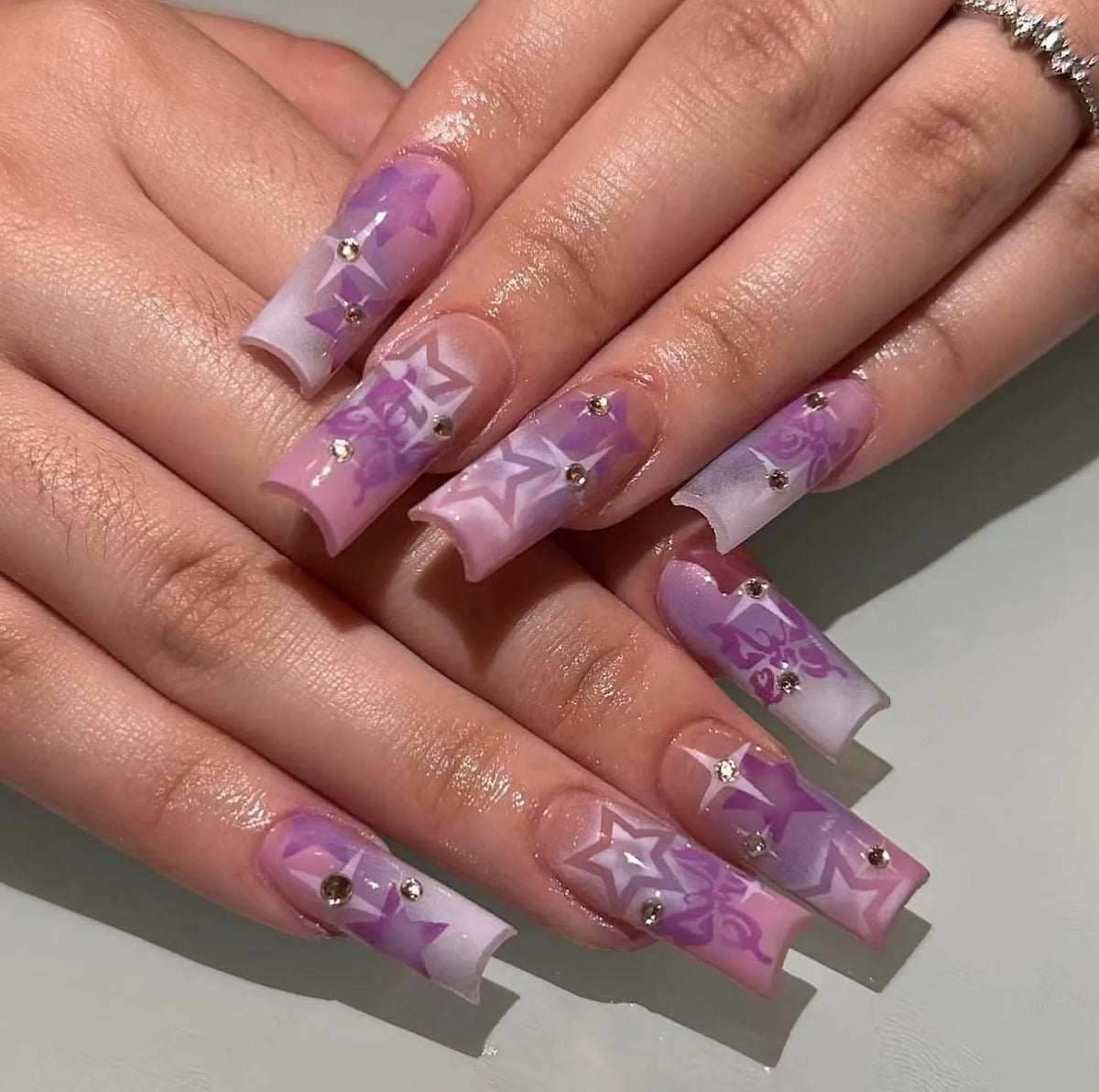 Decorated nail designs shown on hands