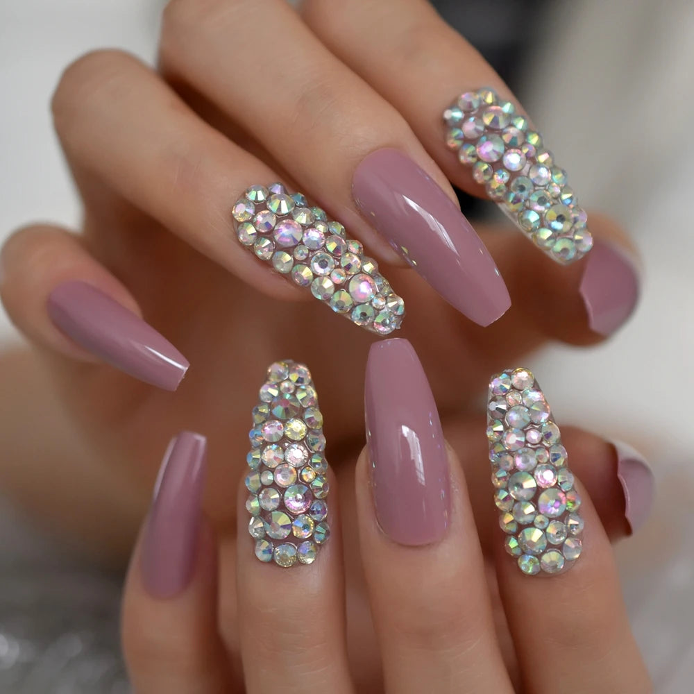Rhinestone-decorated nail designs shown on hands