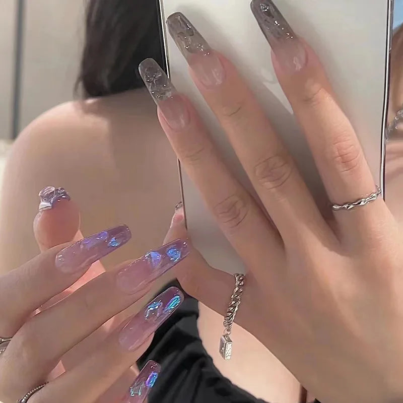 Decorated nail designs shown on hands