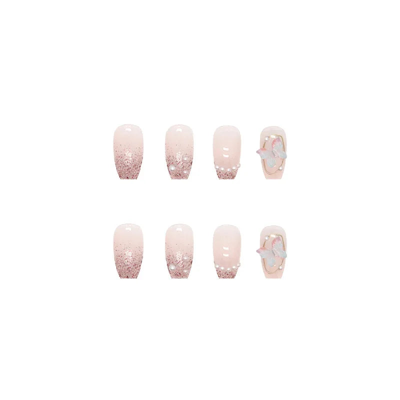 Pink decorated press-on nails arranged on a white background