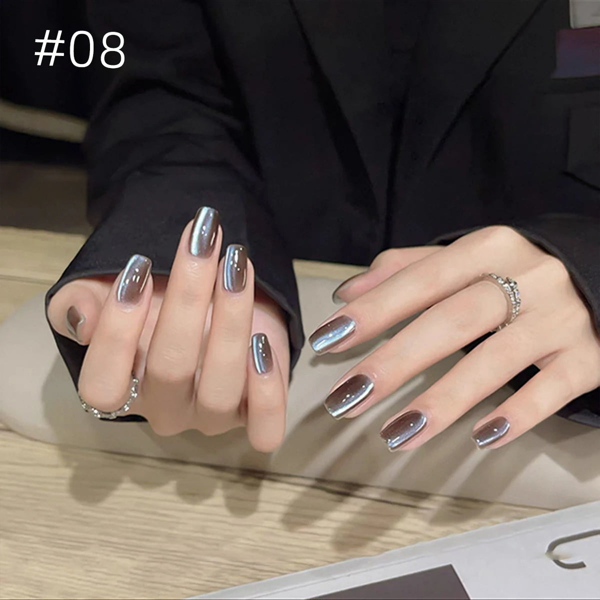 Numbered chrome nail shade shown on hands