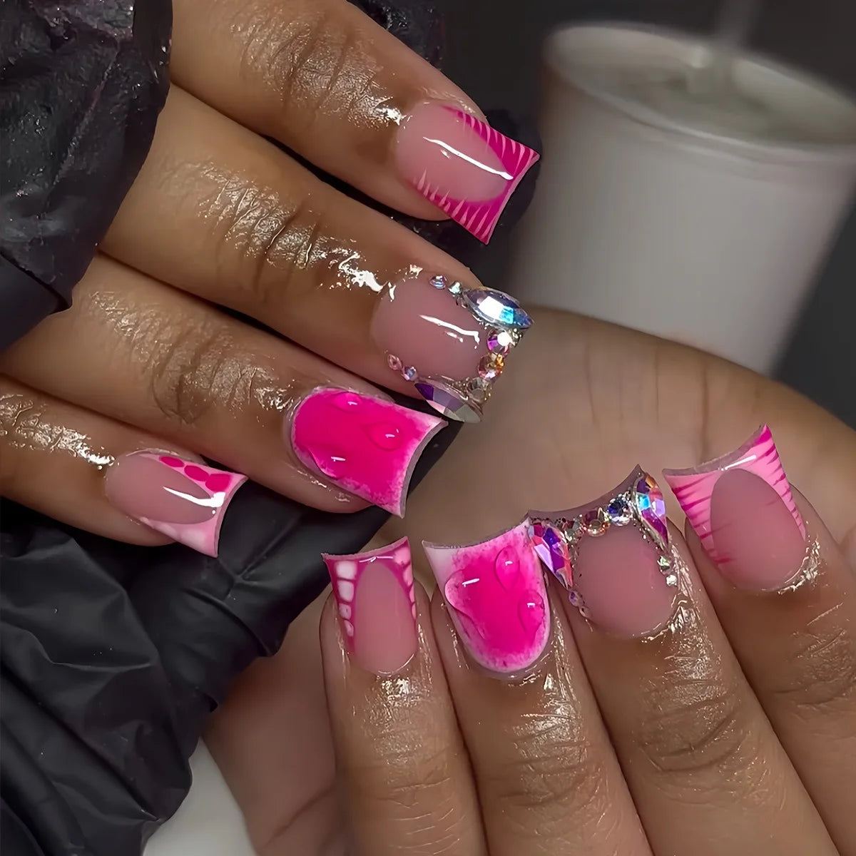 Decorative nail designs with raised accents shown on hands