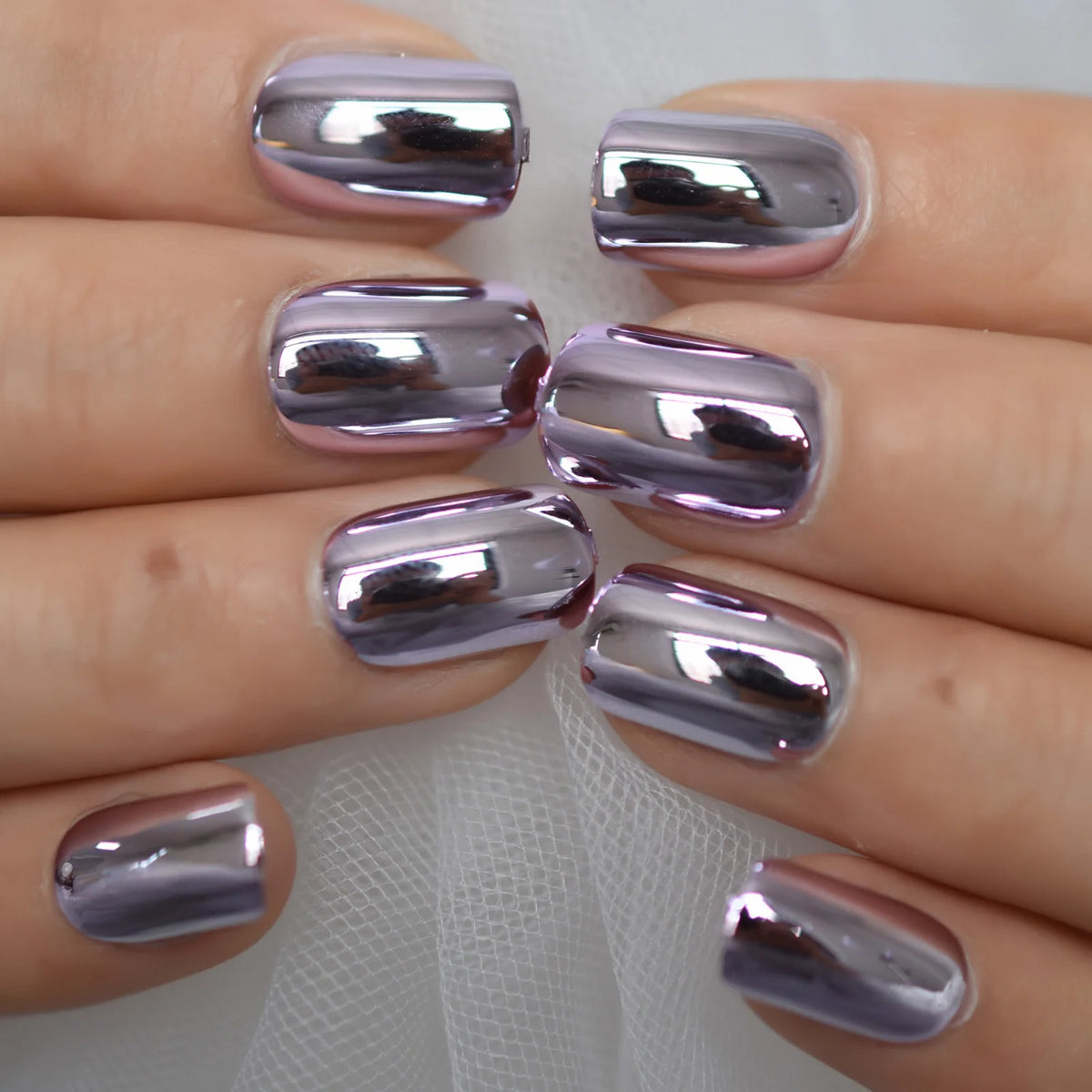 Chrome-finish nails shown on hands