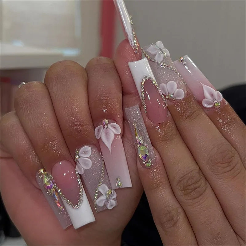 Long decorated nails with raised embellishments shown on hands