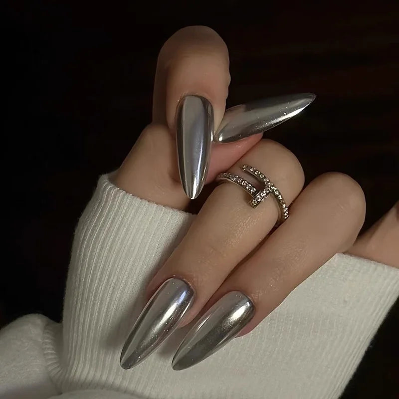 Metallic pointed nails shown on a hand