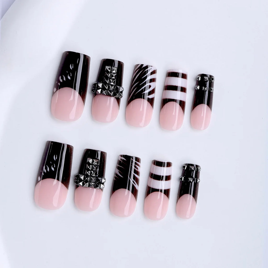 Black and nude press-on nail set arranged in rows