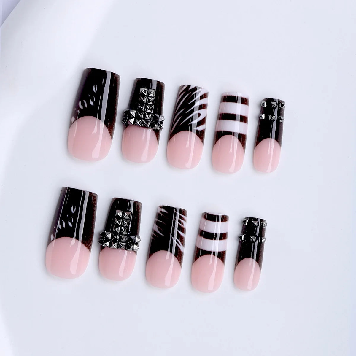 Black and nude press-on nail set arranged in rows