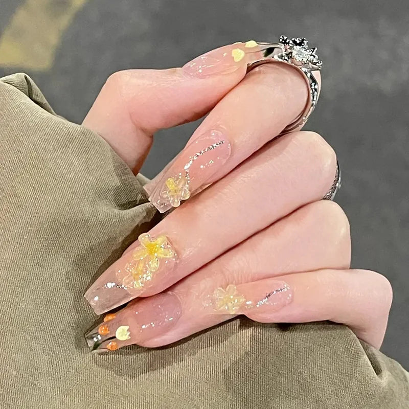 Decorated press-on nail designs shown on hands