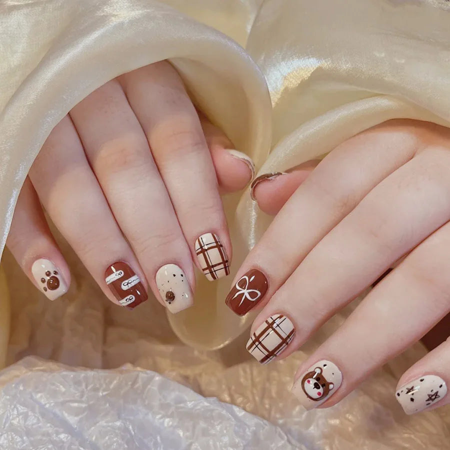Short decorated nails shown on hands