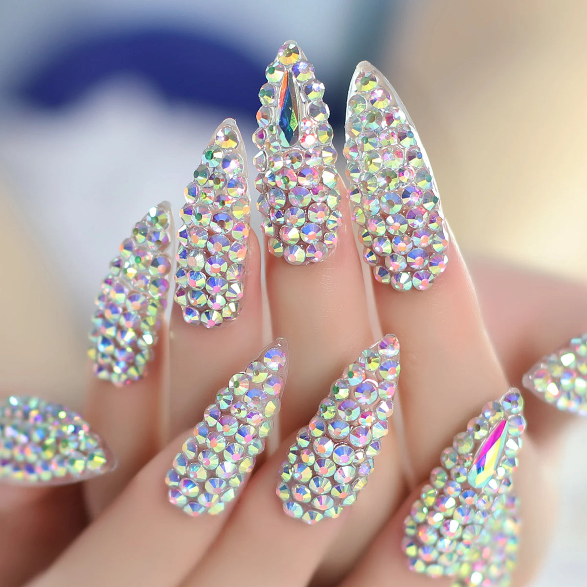 Rhinestone-decorated nail designs shown on hands