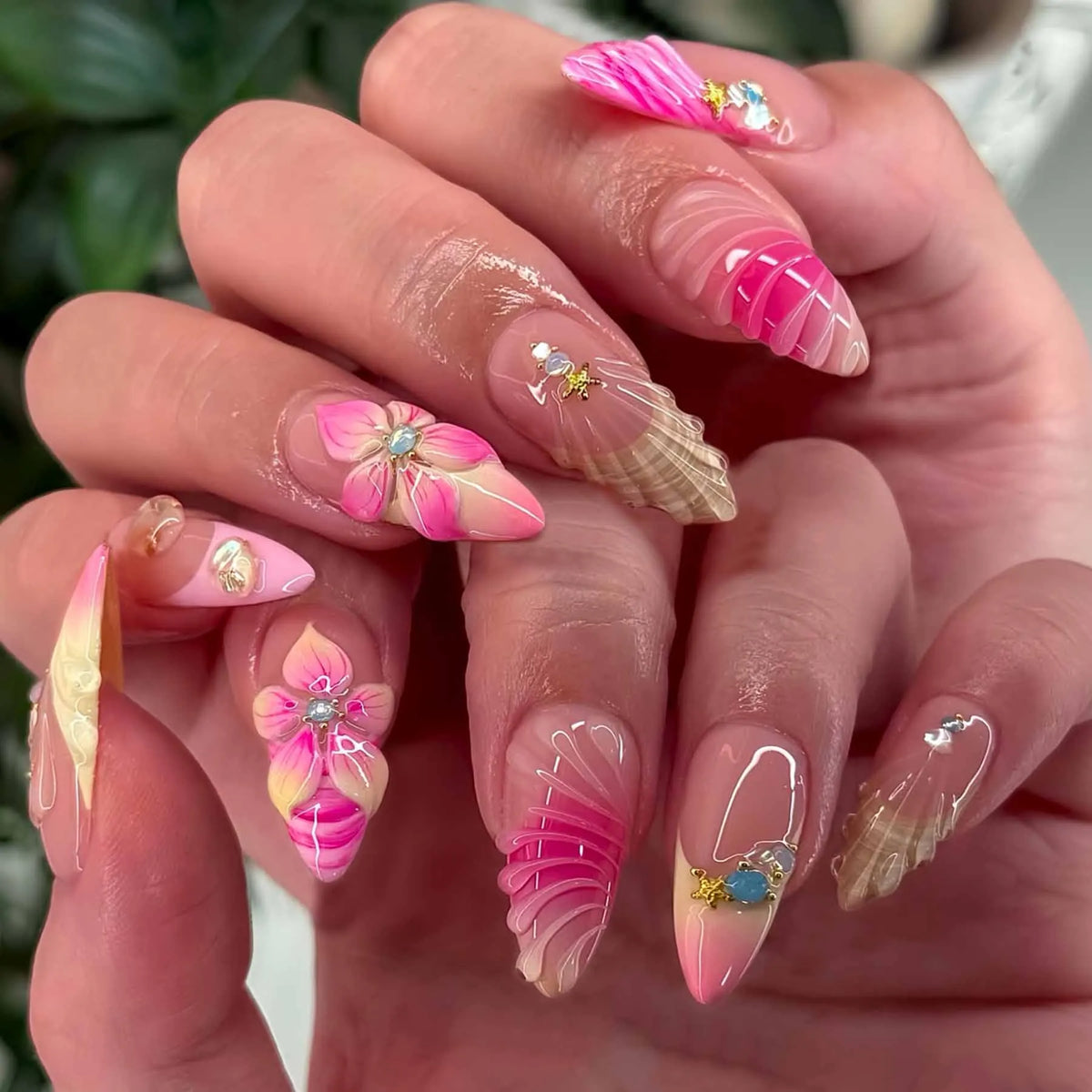 Decorated floral nails shown on hands