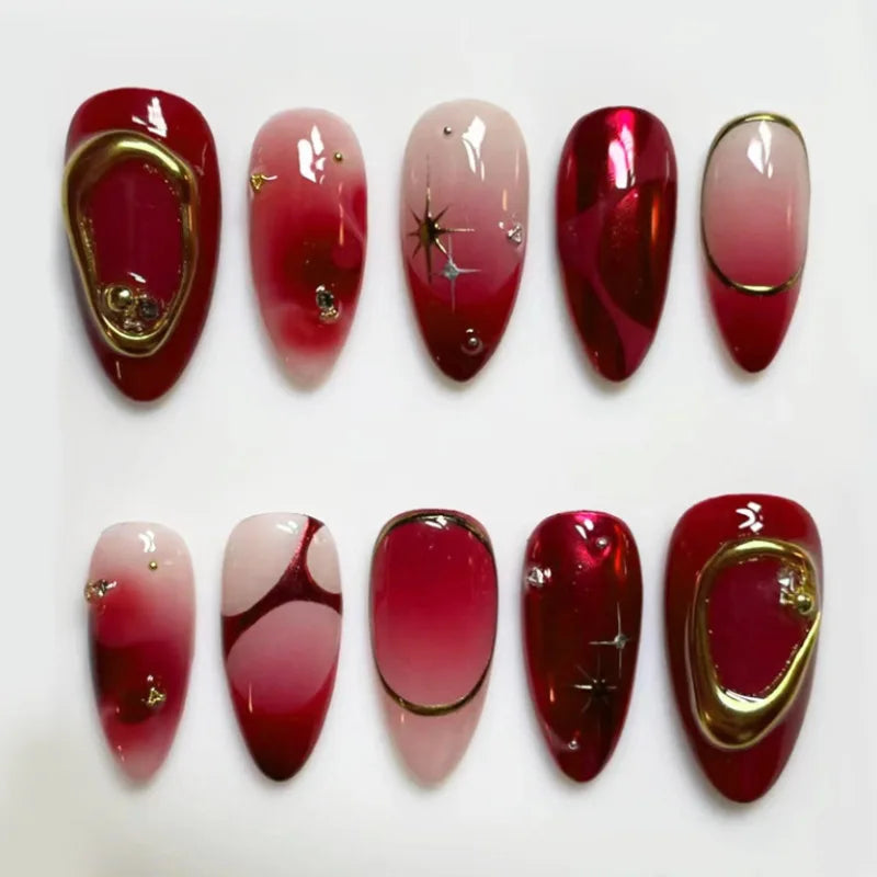 Red and gold press-on nails arranged in rows