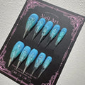 Decorated pointed press-on nails arranged in two rows