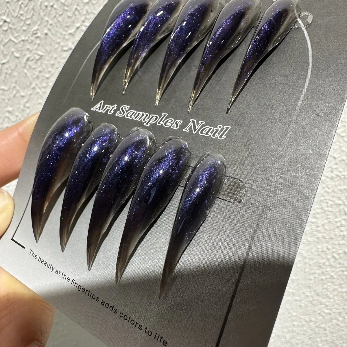 Decorated pointed press-on nails arranged in two rows