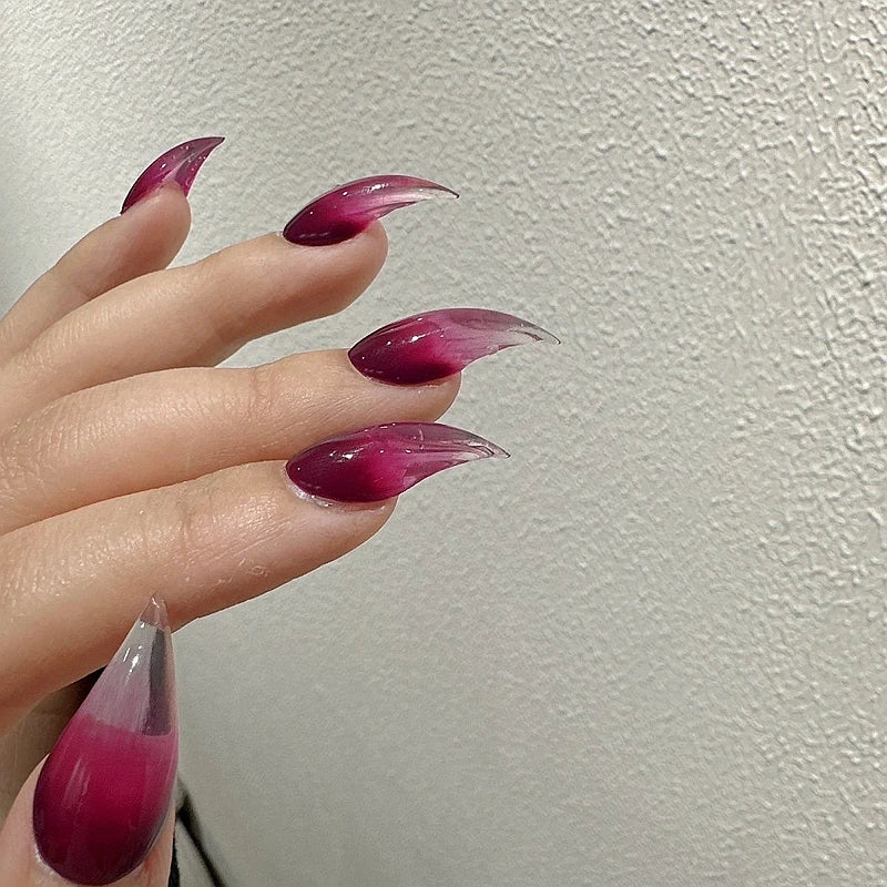 Red pointed nails shown on a hand