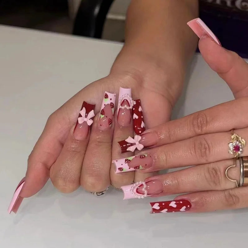 Long decorated nails with raised embellishments shown on hands