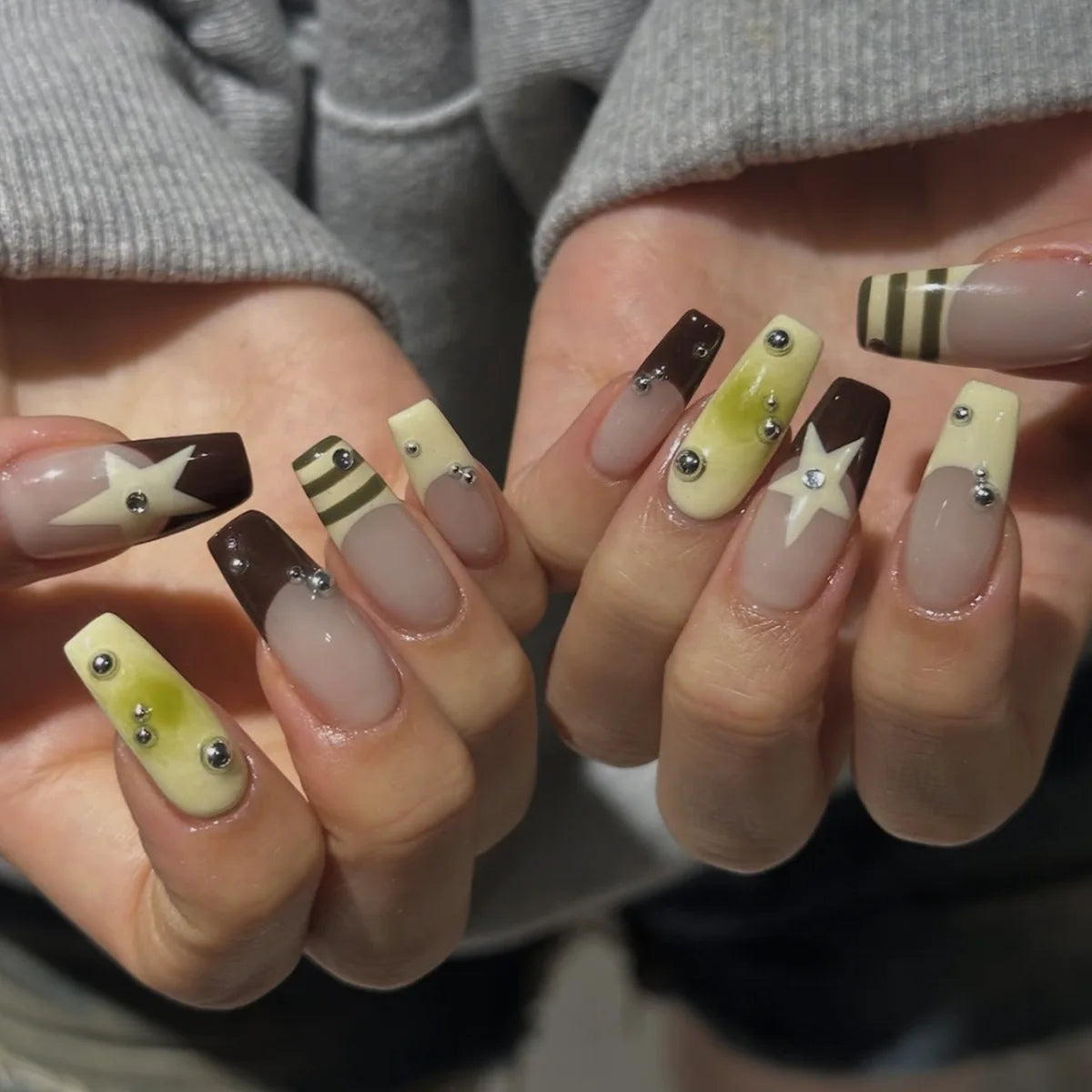 Decorated nail designs shown on hands