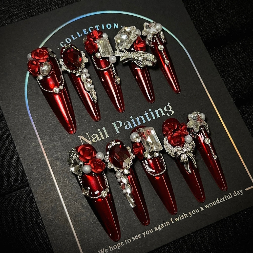Red gem-encrusted press-on nails with manicure or display view
