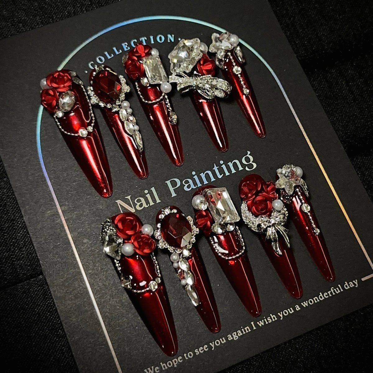 Red gem-encrusted press-on nails with manicure or display view