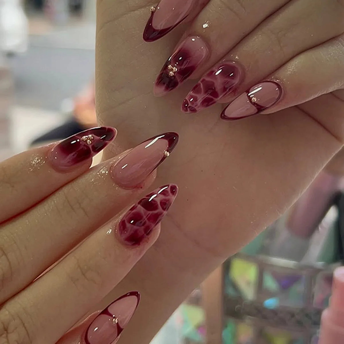 Decorated floral nails shown on hands