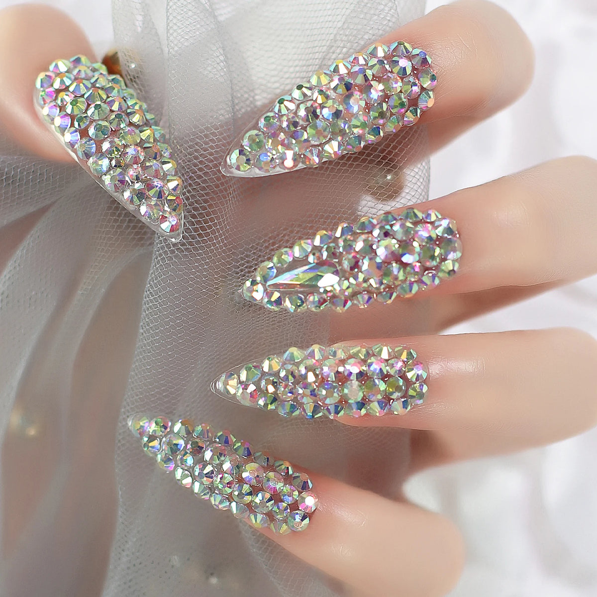 Rhinestone-decorated nail designs shown on hands