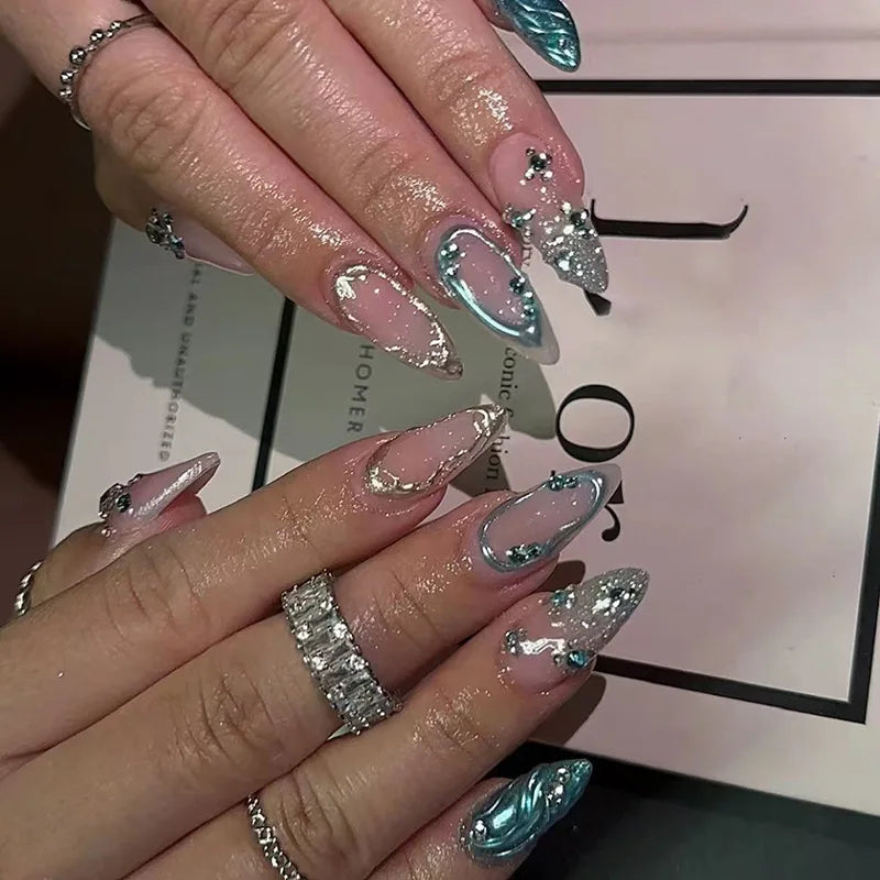 Metallic and embellished nails shown on hands