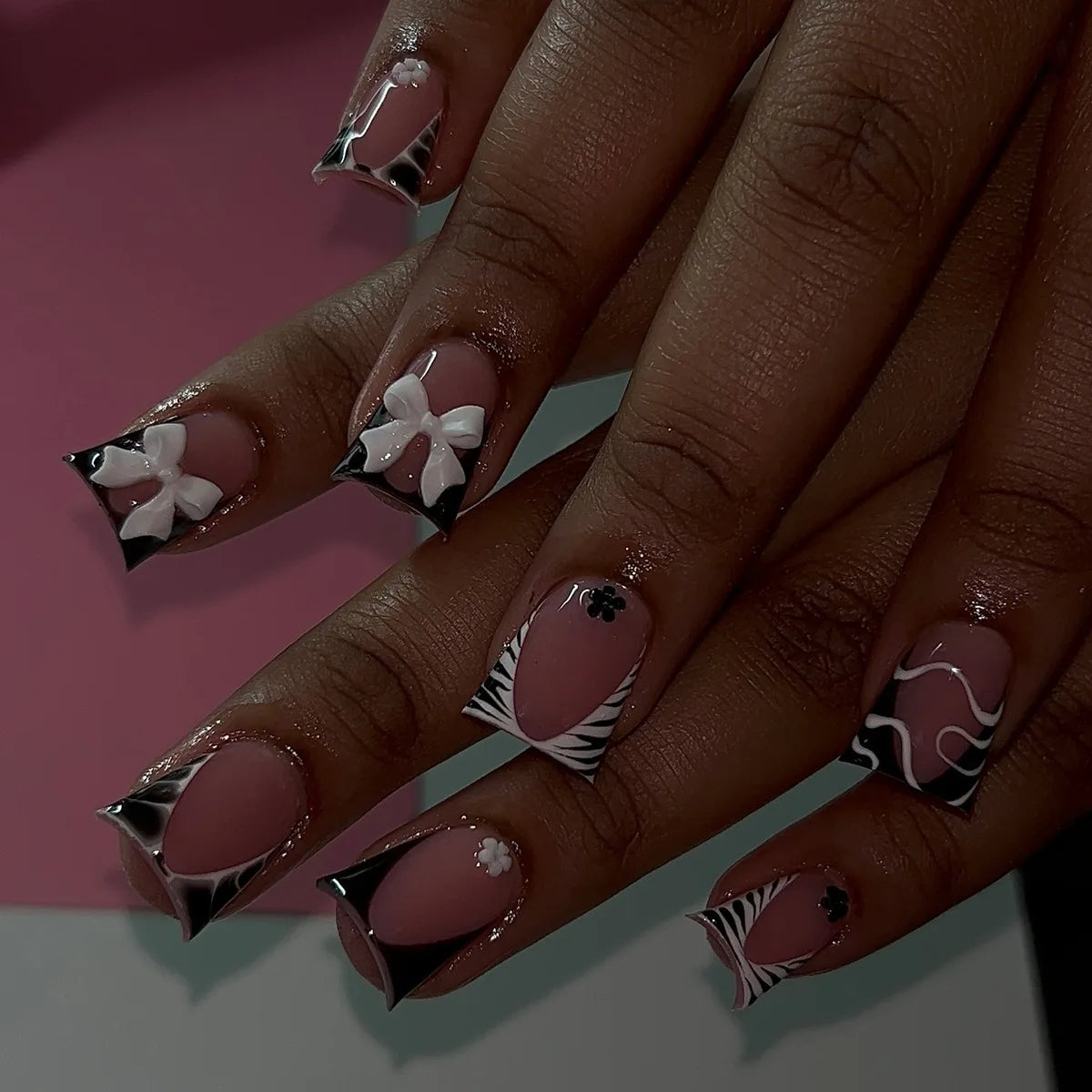 Black and nude nails shown on hands