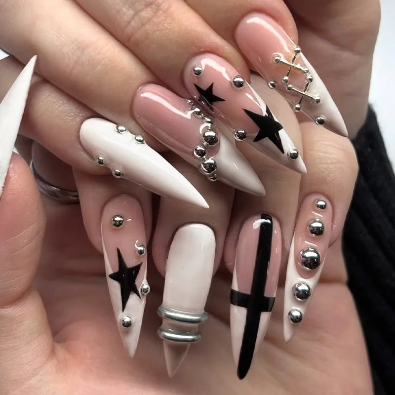 Long pointed nail designs with dark and metallic accents shown on hands