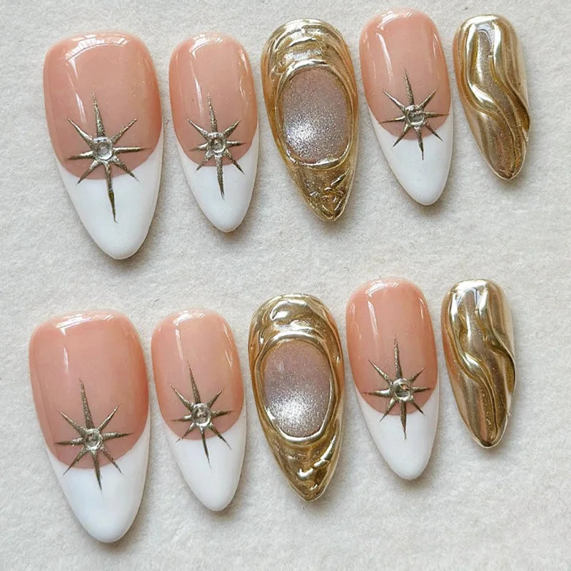 Nude and white press-on nails arranged in two rows with metallic accents