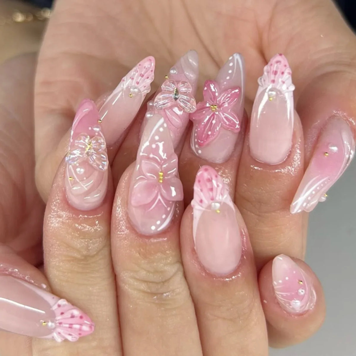 Decorative nail designs with raised accents shown on hands