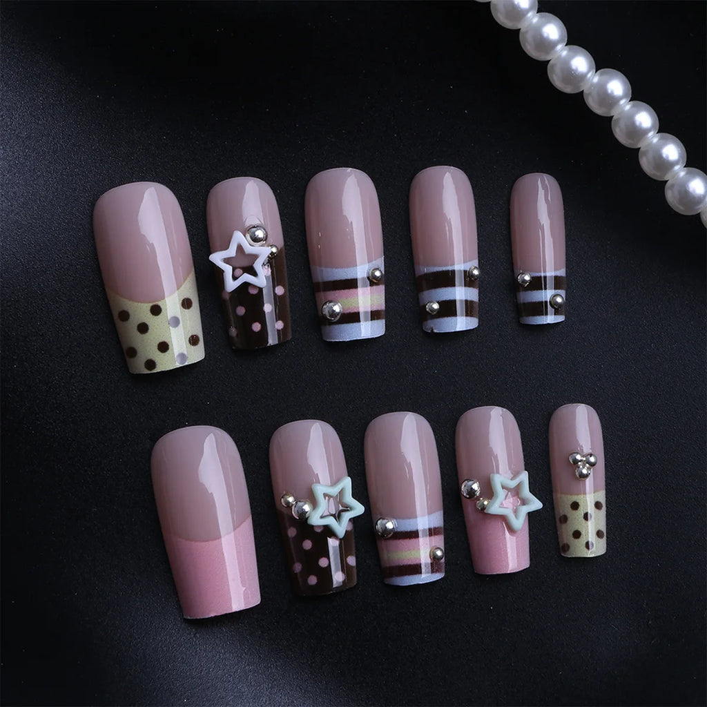 Short decorated press-on nails arranged in rows