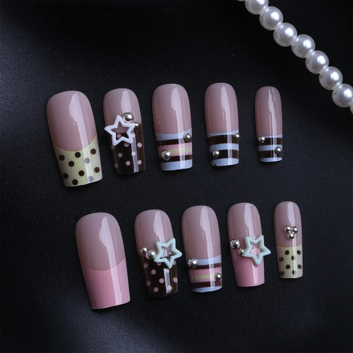 Short decorated press-on nails arranged in rows