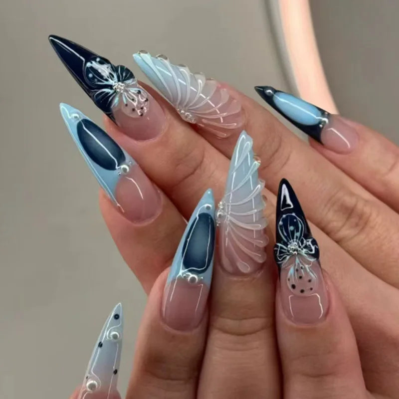 Long pointed decorative nails shown on hands