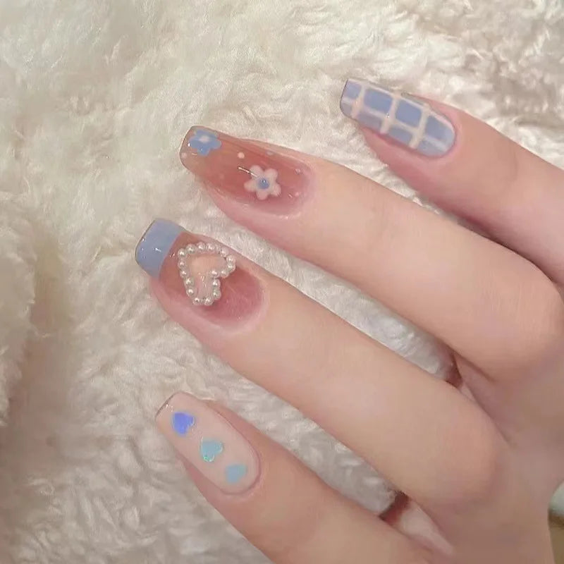 Decorated nail designs shown on hands