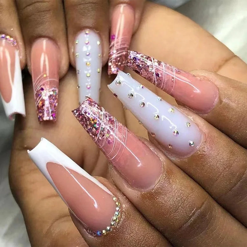 Long decorated nail designs shown on hands