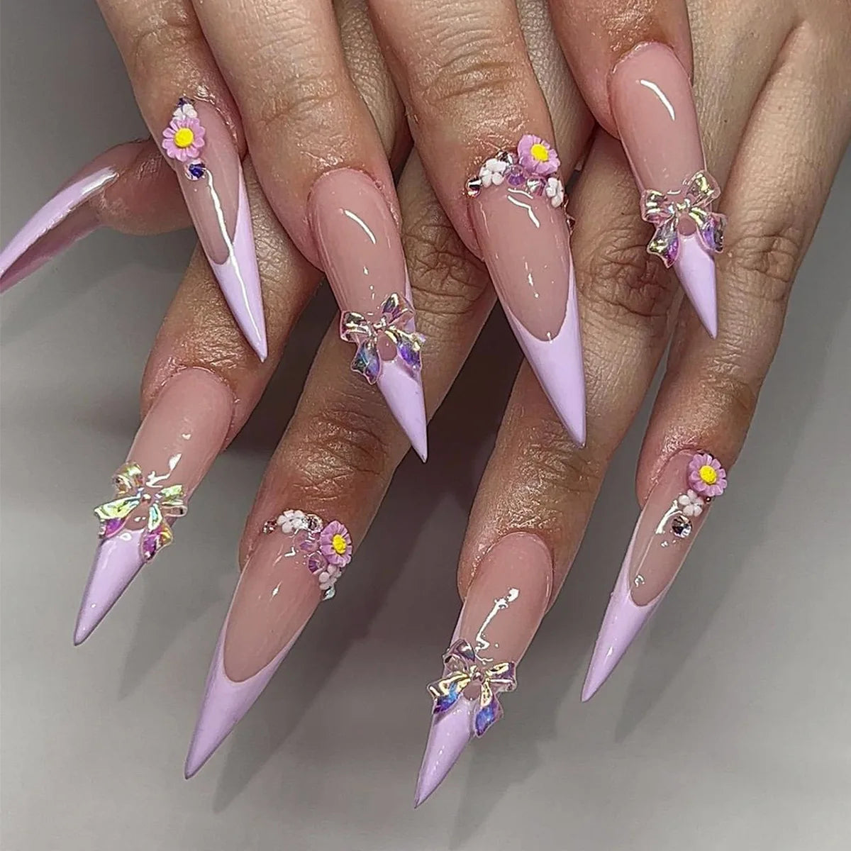 Long decorative nail designs with raised accents shown on hands