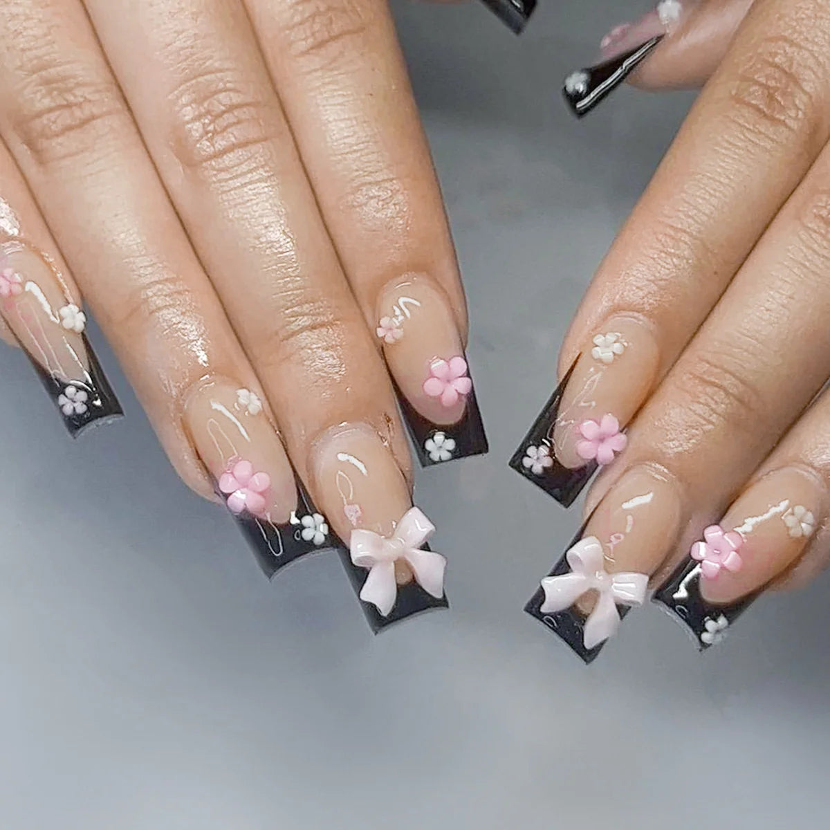 Decorated nail designs shown on hands