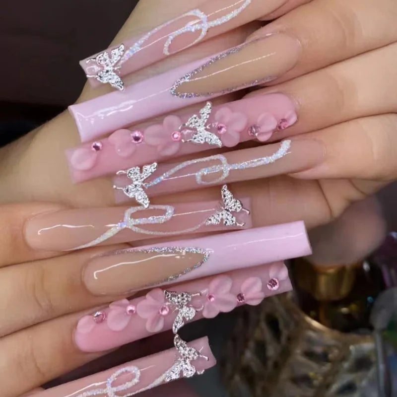 Long decorated nails with raised embellishments shown on hands