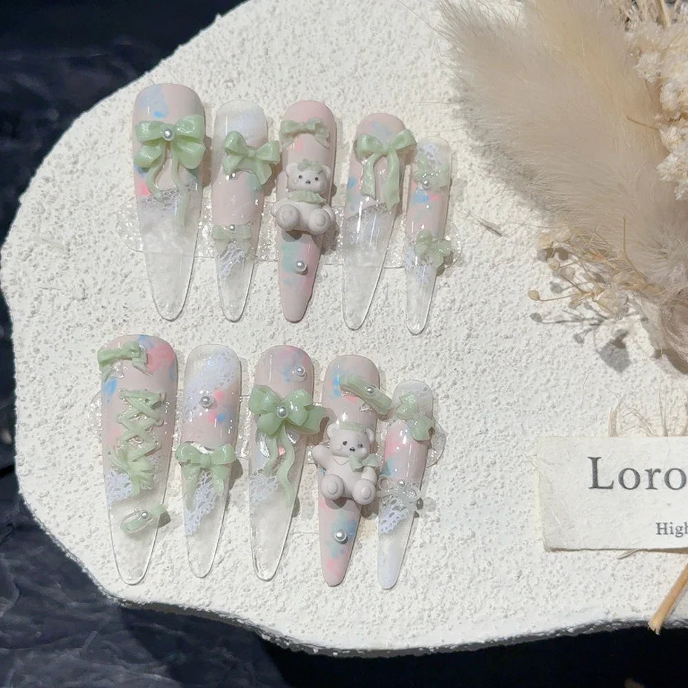 Decorated press-on nail sets with raised embellishments on display cards