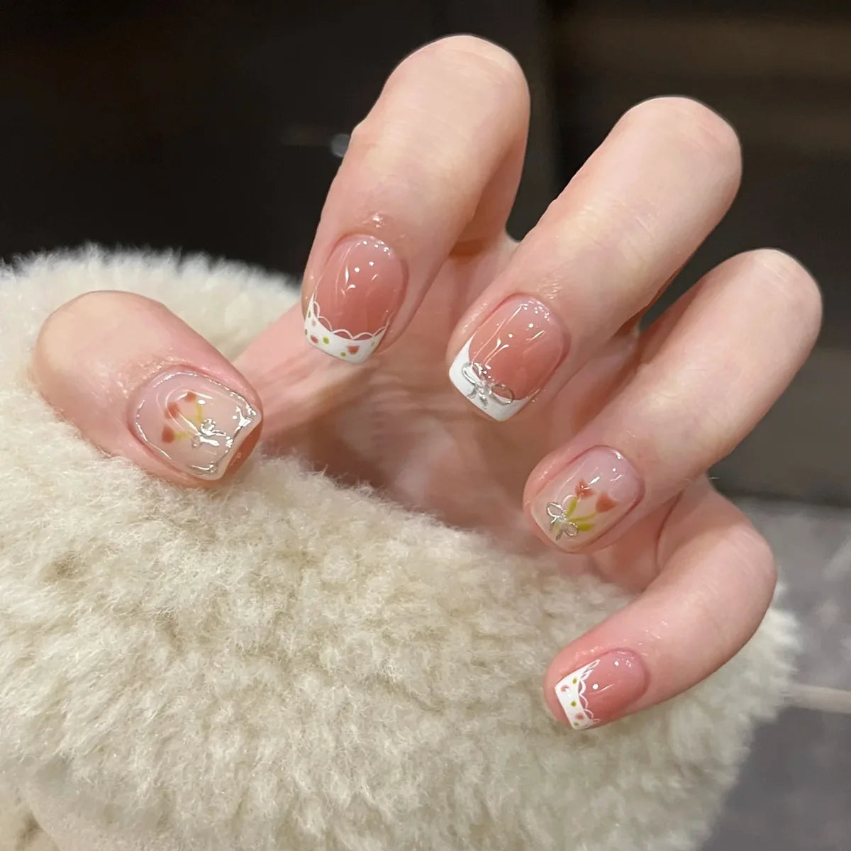 Decorated nail designs shown on hands