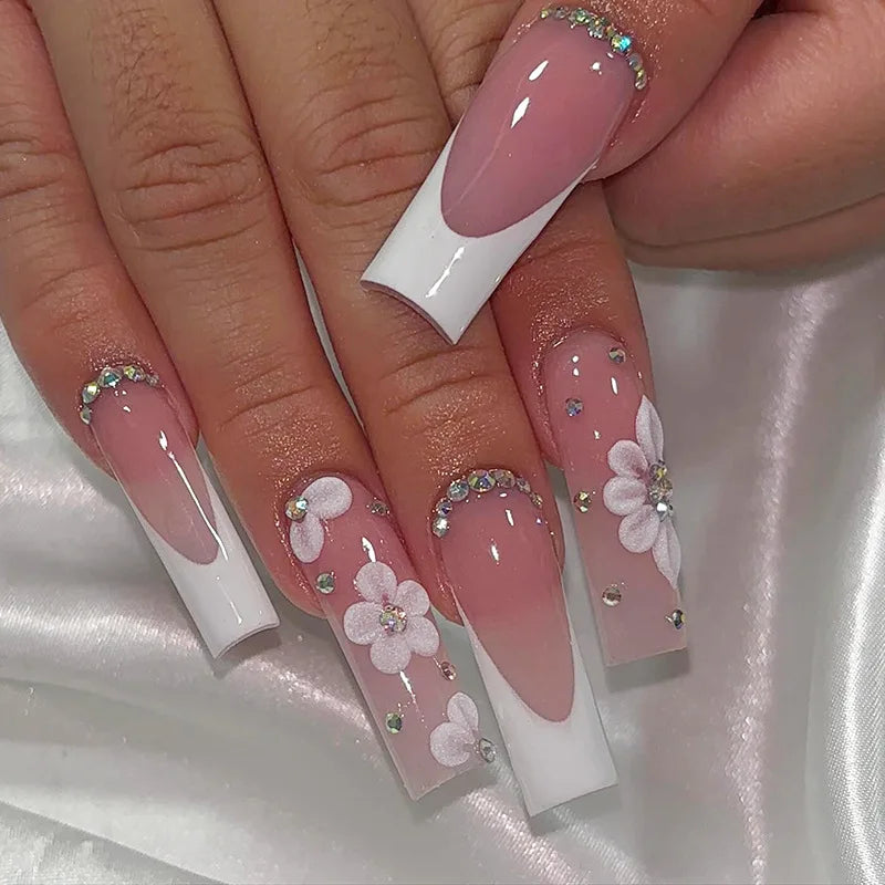 Long decorated nails with raised embellishments shown on hands