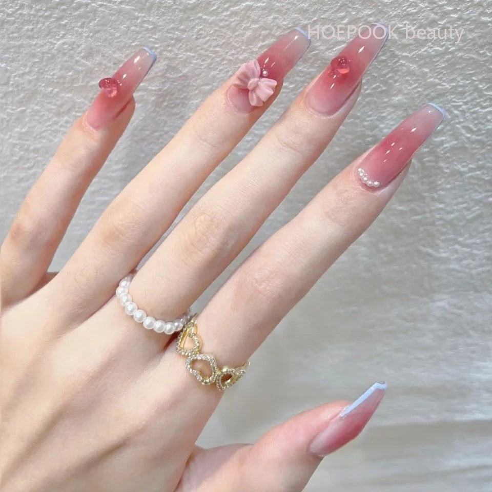 Decorated press-on nail designs shown on hands