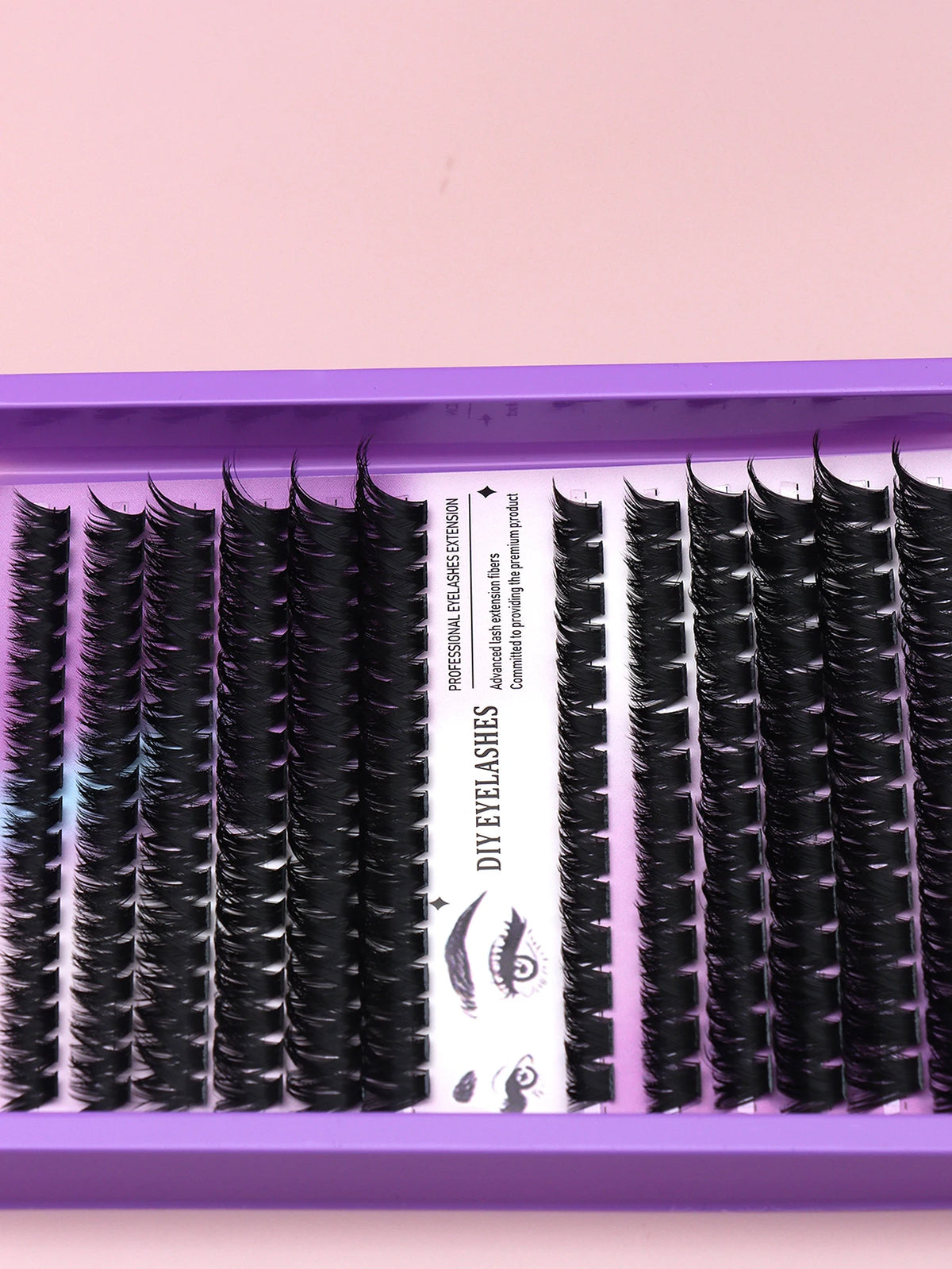False eyelash clusters arranged in rows in a tray