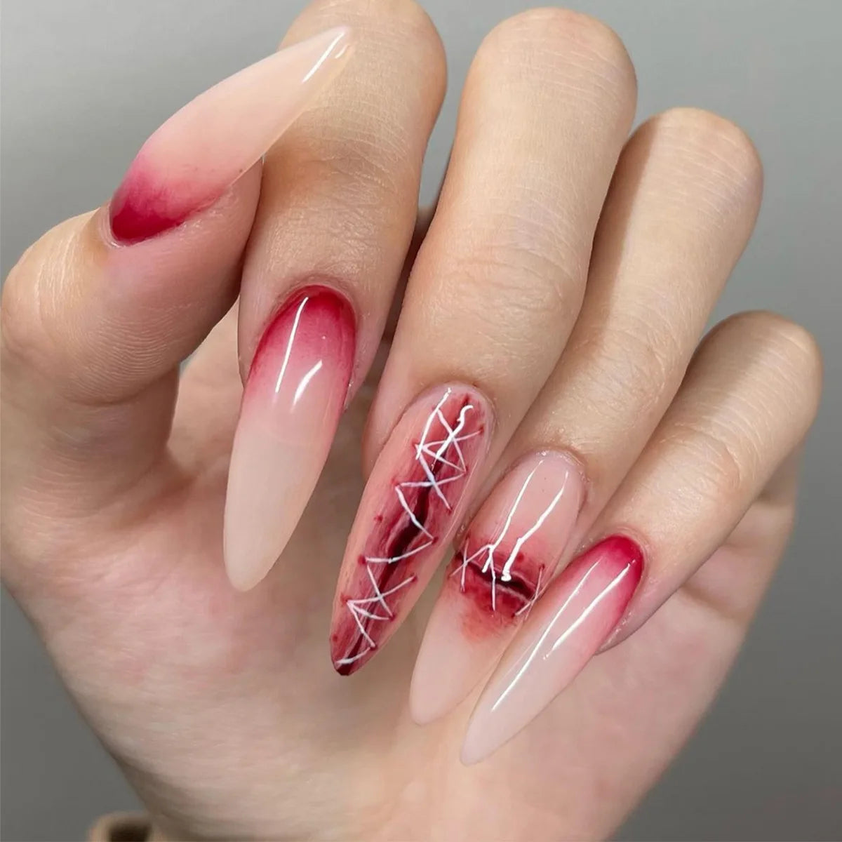 Long pointed decorative nails shown on hands