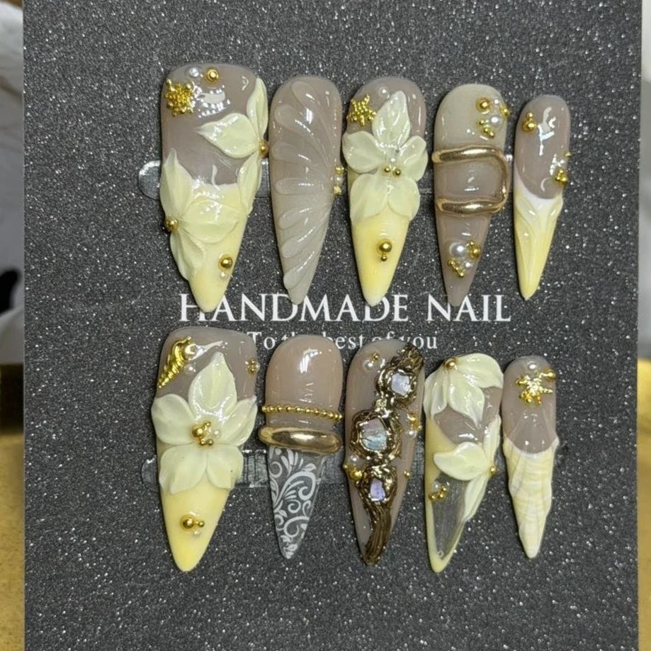 Decorated pointed press-on nails arranged in rows