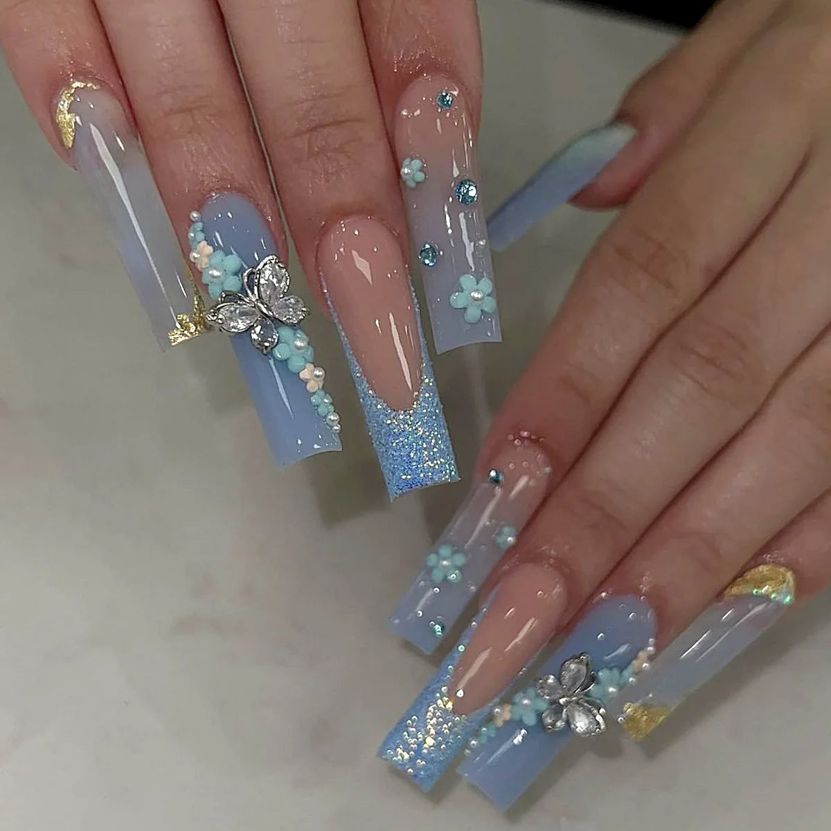 Long decorated nail designs shown on hands
