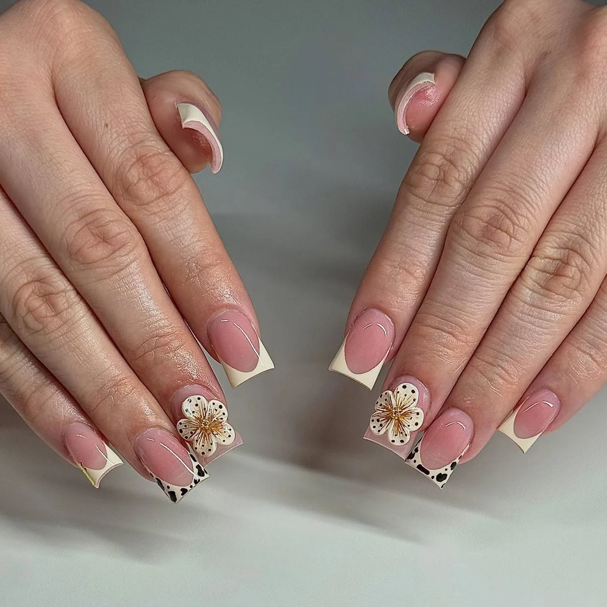 Decorative nail designs with raised accents shown on hands