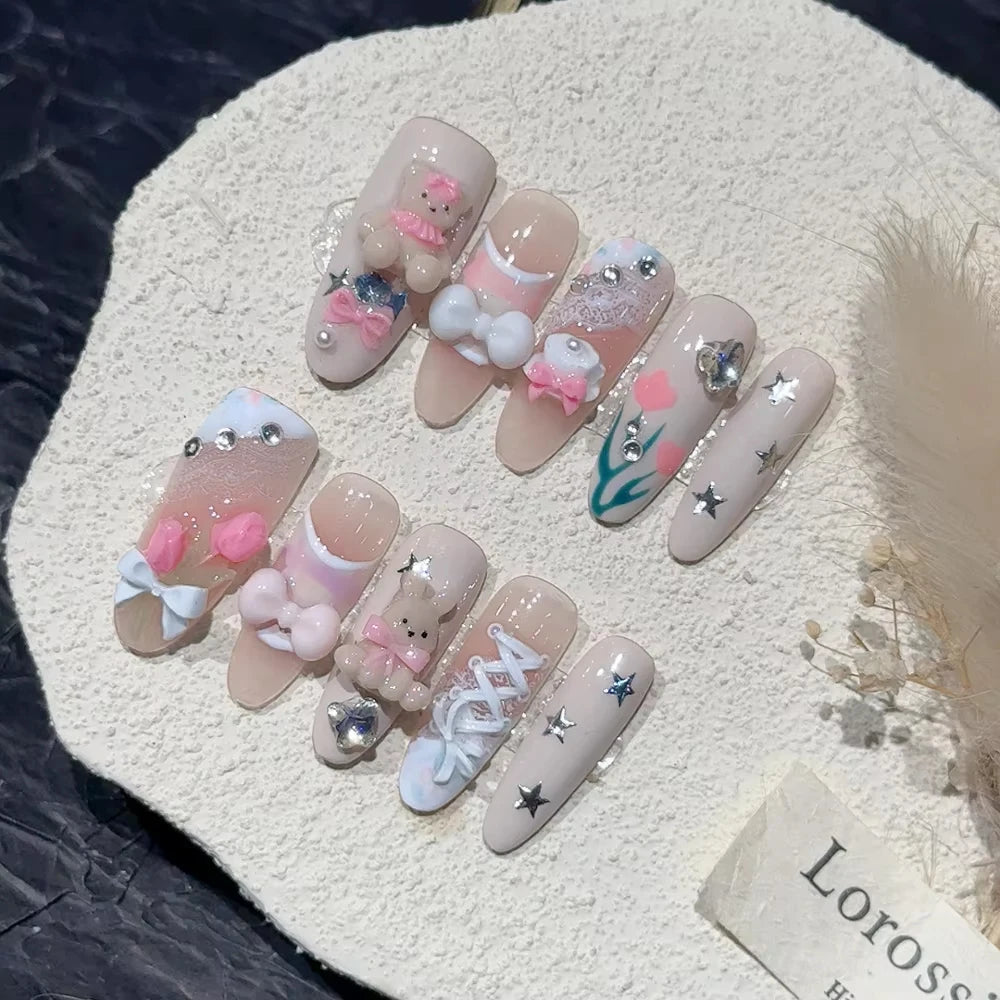 Decorated press-on nail sets with raised embellishments on display cards