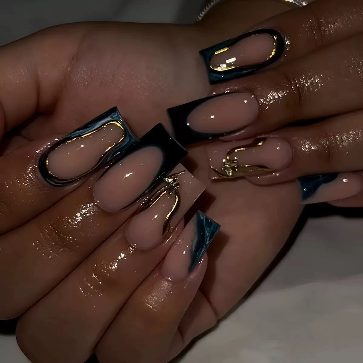 Long decorated nail designs shown on hands