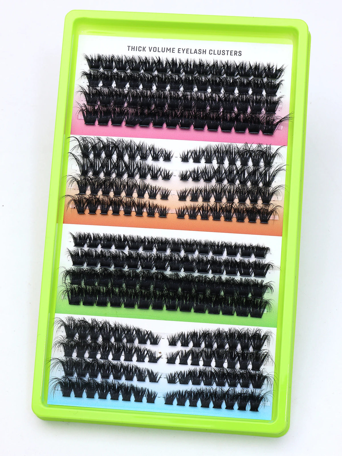 False eyelash clusters arranged in rows in a tray